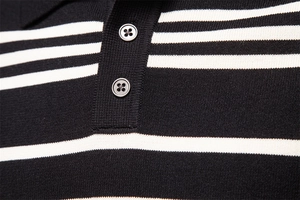 Macro shot of two buttons and striped knit texture on a men's polo sweater collar