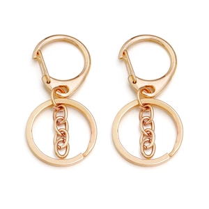 Detailed view of two gold-plated alloy D-ring lobster clasps with chains and key rings