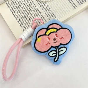 Close-up of blue plush flower pendant with pink embroidery and metal spring buckle