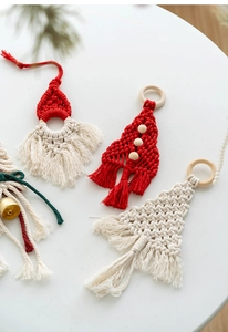 Detail of handmade macramé Christmas tree and Santa pendants with wooden rings