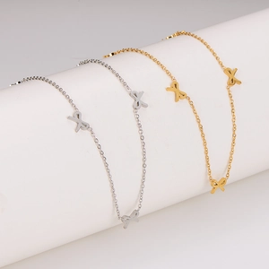 Elegant gold and silver stainless steel bow knot necklaces on white display stands