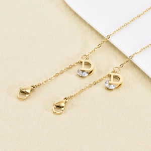 Gold plated stainless steel face mask chain featuring a D-letter charm with clear crystals