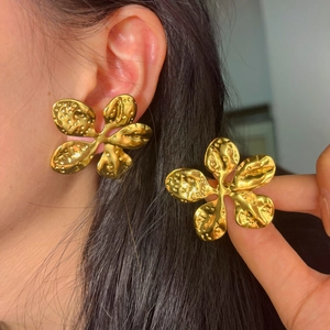 Elegant gold flower stud earrings with hammered texture and exaggerated floral design
