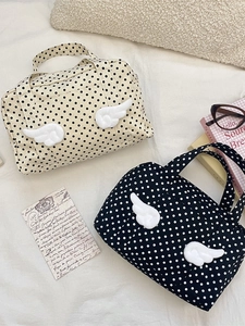 Polka dot travel cosmetic bags with plush wing handles in beige and black styles
