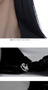 Macro shot of silver lava texture earring with black gemstone and engraved breakthrough text