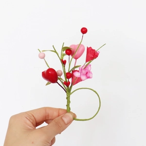 Detail of handmade napkin ring with red heart, pink berries for Valentine decor