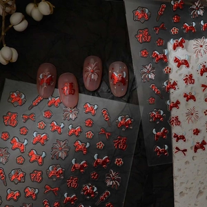Detailed view of red metallic Chinese New Year nail stickers with festive gold foil accents