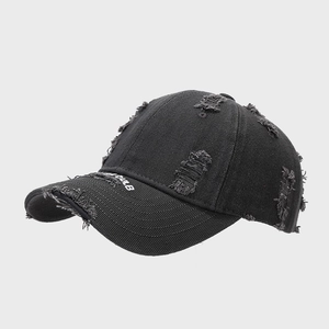 Close-up of distressed black denim baseball cap featuring white CLUB brim embroidery