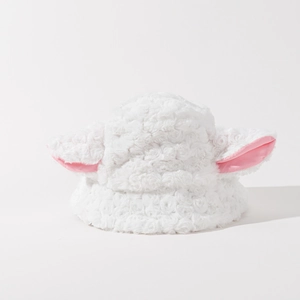 Detail of plush lamb ear bucket hat showing soft white fleece and pink ear accents