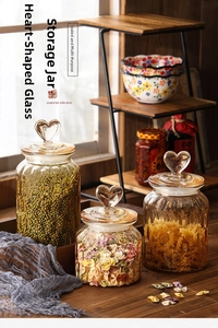 Detail of amber glass jars with vertical ridges and heart-shaped lids set of three