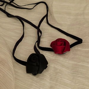 Elegant fabric rose choker necklaces in red and black ribbon with a minimalist silk texture