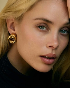 Macro shot of 18k gold-plated triple interlocking hoop earrings for women