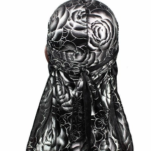 Silky durag with silver rose pattern on black fabric shown on a model from the back