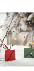 Close-up of festive red and green envelope-style Christmas tree hanging ornaments