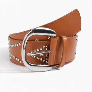 Macro detail of brown leather belt with silver horseshoe buckle and triangle rivet patterns