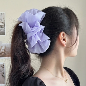 Elegant lavender chiffon oversized scrunchie worn as a hair decoration on a model