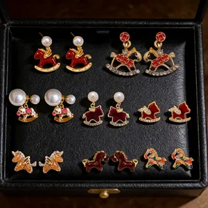 18K gold plated horse stud earrings with colorful enamel and pearls on black leather