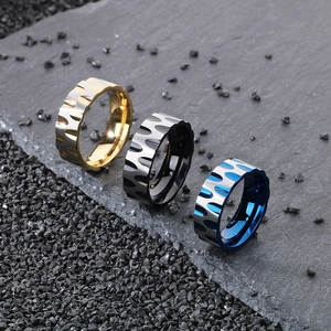 Detail of wavy titanium steel rings for men in gold, black, and blue finishes