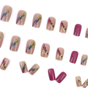 Colorful gradient press-on nails with abstract patterns and glossy fuchsia finish