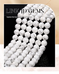 Macro view of polished white howlite round beads with natural grey marble veins
