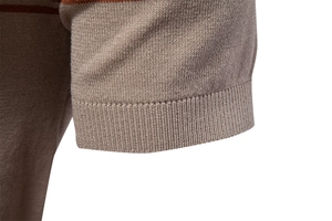 Close-up of khaki knit polo shirt cuff showing fine texture and ribbed stripe detail