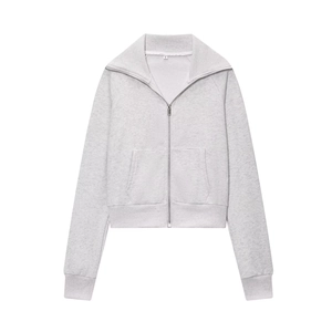 Detailed close-up of light gray knit fabric texture and silver zipper on zip-up jacket