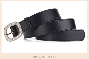 Macro detail of black leather belt with a square buckle featuring inlaid sparkling rhinestones