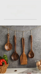 Macro detail of teak wood kitchen utensil set hanging on a rustic wall hooks