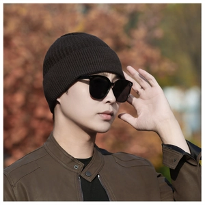Detailed view of dark brown ribbed knit beanie with thick winter wool texture