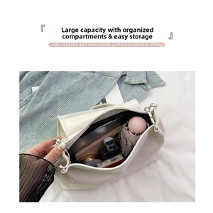 Detail view of large capacity white tote bag interior storing daily essentials and phone