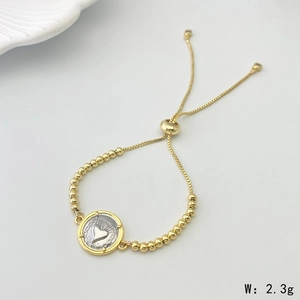 Detail of a 2.3g golden beaded bracelet featuring a silver heart St. Benedict charm