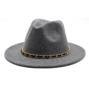 Detailed texture of gray wool felt fedora with decorative gold and black metal chain