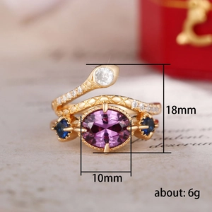 Vintage gold snake ring with purple oval gemstone and sparkling white crystals