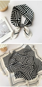 Detail of satin square scarf with black and white geometric maze pattern textures