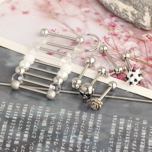 Detailed close-up of mixed stainless steel body piercing jewelry with decorative beads