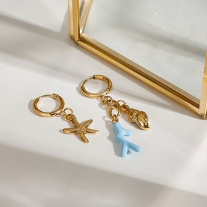 Gold stainless steel ocean earrings featuring starfish and blue coral branch charms