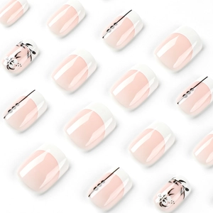 Short French tip press on nails with white floral art and black leaf details