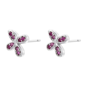 Macro shot of silver butterfly earrings set with round ruby gemstones on a white base