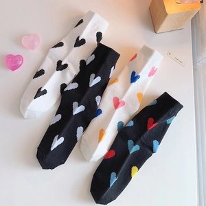 Set of four cotton crew socks with colorful heart patterns in black and white colors