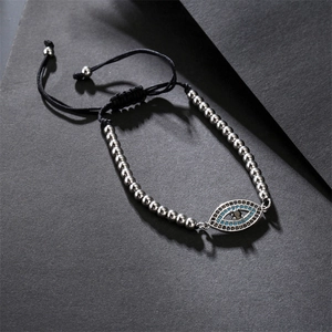 Detailed view of woven Evil Eye bracelet with blue zircon inlay and adjustable black cord