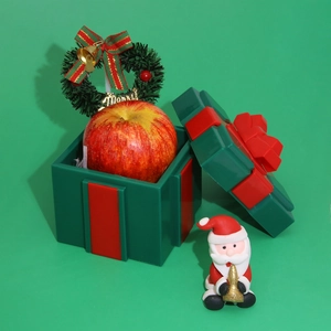Creative Christmas Santa gift box with apple and Merry mini wreath decoration in red and green