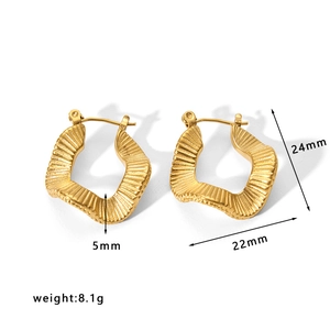 Macro shot of gold hollow earrings showing detailed size measurements 24mm by 22mm