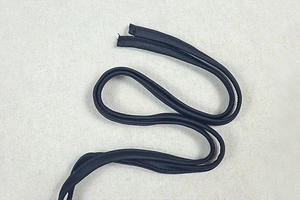 Close-up of black knitted bodysuit straps with precise double-stitch detailing