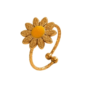Detailed view of sunflower ring with yellow enamel center and hammered adjustable band