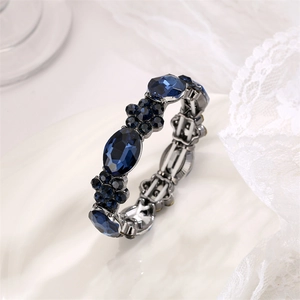 Close-up of vintage bracelet with blue faceted glass stones in a floral silver setting