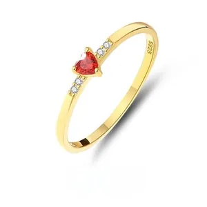 Dettaglio dell'anello in argento S925 dorato con gemma a cuore rossa e zirconi chiari