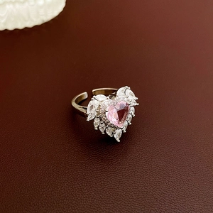 Macro shot of silver ring featuring heart pink gem and marquise cut zircon stones