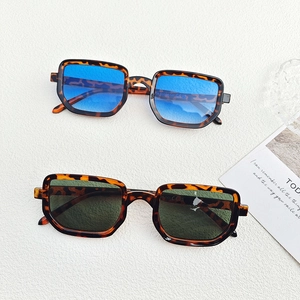 Flat lay of retro leopard print square sunglasses with blue and green gradient lenses