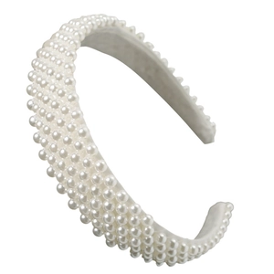 Close-up of white pearls on a wide baroque headband showing elegant glossy details