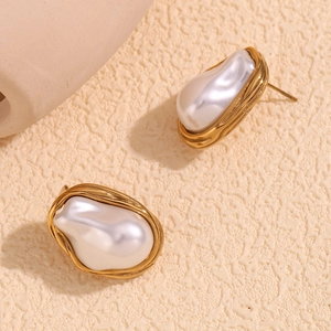Detailed view of baroque pearl stud earrings with textured 18K gold-plated base